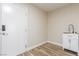 Utility room featuring a sink, cabinet, and direct access to the outside at 7338 Flying Pegasus Ct, Las Vegas, NV 89131