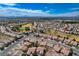 This aerial perspective showcases community homes, golf courses, landscaping, and mountain views against a bright skyline at 7564 Wingspread St, North Las Vegas, NV 89084