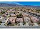 An aerial view captures rows of single-story homes with desert landscaping, set against a mountain backdrop at 7564 Wingspread St, North Las Vegas, NV 89084