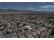 An aerial view shows the neighborhood's layout with mountains in the distance, landscape, and rows of homes at 7564 Wingspread St, North Las Vegas, NV 89084