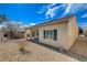 An angled view of the backyard shows the patio, decorative rocks, and fence line at 7564 Wingspread St, North Las Vegas, NV 89084