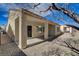 The exterior view of the backyard showing the covered patio and the decorative rock landscaping at 7564 Wingspread St, North Las Vegas, NV 89084