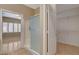Bright bathroom features a glass-enclosed shower, plus a view into an adjacent bedroom at 7564 Wingspread St, North Las Vegas, NV 89084