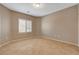 This bedroom features neutral walls, tile floors, and a window at 7564 Wingspread St, North Las Vegas, NV 89084