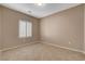 Bright, neutrally painted bedroom features shuttered windows and tiled floors at 7564 Wingspread St, North Las Vegas, NV 89084