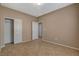 Neutral bedroom with tile floors, closet, and white doors leading to other rooms at 7564 Wingspread St, North Las Vegas, NV 89084