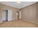 View of bedroom showing closet doors, neutral walls, tile floors, and access to other rooms at 7564 Wingspread St, North Las Vegas, NV 89084