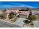 Single Gathering home featuring a two-car garage, desert landscaping, and mountain views at 7564 Wingspread St, North Las Vegas, NV 89084