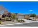 Charming single-story home featuring a well-manicured yard, desert landscaping, and a convenient two-car garage at 7564 Wingspread St, North Las Vegas, NV 89084