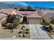 Charming single-story home featuring a well-manicured yard, desert landscaping, and a convenient two-car garage at 7564 Wingspread St, North Las Vegas, NV 89084
