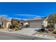 Charming single-story home featuring a well-manicured yard, desert landscaping, and a convenient two-car garage at 7564 Wingspread St, North Las Vegas, NV 89084