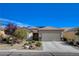 Charming single-story home featuring a well-manicured yard, desert landscaping, and a convenient two-car garage at 7564 Wingspread St, North Las Vegas, NV 89084