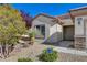 Inviting front entrance with desert landscaping, and a charming front door at 7564 Wingspread St, North Las Vegas, NV 89084