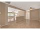 Open living area featuring tile flooring, neutral walls, and natural light at 7564 Wingspread St, North Las Vegas, NV 89084