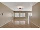 Spacious living room features large windows, neutral walls, and ceramic tile flooring at 7564 Wingspread St, North Las Vegas, NV 89084