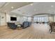 A spacious lounge features modern furnishings and large windows with natural light, creating a relaxing ambiance at 7564 Wingspread St, North Las Vegas, NV 89084