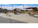 Community patio with outdoor tables, chairs, and sun umbrellas overlooking a manicured golf course at 7564 Wingspread St, North Las Vegas, NV 89084