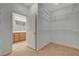 Spacious walk-in closet boasts wire shelving and neutral walls and is accessible from the bathroom at 7564 Wingspread St, North Las Vegas, NV 89084