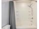 The all white bathtub offers wall shelves and mounted shower head fixture at 7649 Calico Fields St, Las Vegas, NV 89149