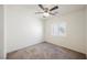 Cozy bedroom featuring a ceiling fan, window and plush carpet flooring at 7649 Calico Fields St, Las Vegas, NV 89149