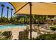 Inviting community pool features lounge chairs and shade canopies for a relaxing experience at 7649 Calico Fields St, Las Vegas, NV 89149