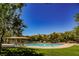 Resort-style community pool surrounded by lush landscaping and comfortable lounge chairs at 7649 Calico Fields St, Las Vegas, NV 89149