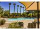 Inviting community pool with lounge chairs and lush landscaping for a relaxing experience at 7649 Calico Fields St, Las Vegas, NV 89149