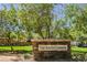 Stone sign for 'The South Commons' community with lush trees and landscaping on a sunny day at 7649 Calico Fields St, Las Vegas, NV 89149