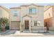 Charming two-story home featuring a garage, a cozy front porch, and a well-maintained yard at 7649 Calico Fields St, Las Vegas, NV 89149