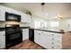 Bright kitchen with white cabinetry, black appliances, and a stainless steel sink at 7649 Calico Fields St, Las Vegas, NV 89149
