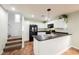 Clean kitchen with white cabinetry, black appliances, and a functional island, enhancing the cooking experience at 7649 Calico Fields St, Las Vegas, NV 89149
