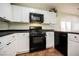 Kitchen featuring black appliances, white cabinets and drawers, and modern tile floors at 7649 Calico Fields St, Las Vegas, NV 89149