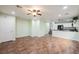 Spacious living room with tile floors, fan and bright recessed lighting, with adjacent stairway and kitchen at 7649 Calico Fields St, Las Vegas, NV 89149