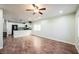 Open living room with tile floors, fan and bright recessed lighting, adjacent to the modern kitchen at 7649 Calico Fields St, Las Vegas, NV 89149