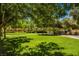 Expansive green park area with mature trees providing ample shade for residents to relax and enjoy at 7649 Calico Fields St, Las Vegas, NV 89149