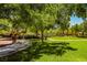 Lush green park area with sidewalks, mature trees, and playground equipment for recreation at 7649 Calico Fields St, Las Vegas, NV 89149