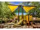 Vibrant playground for children, complete with slides, climbing structures and colorful shade canopies at 7649 Calico Fields St, Las Vegas, NV 89149