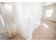 Bright staircase area showcasing light walls, carpeted stairs, and natural light from a window at 7649 Calico Fields St, Las Vegas, NV 89149