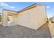 The backyard features a covered patio and neutral siding with gravel at 7904 Fantail Dr, North Las Vegas, NV 89084