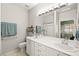 Bright bathroom with double sinks, large mirror, and shower with glass door at 7904 Fantail Dr, North Las Vegas, NV 89084