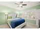 Comfortable bedroom featuring a ceiling fan, large window, and plush bedding at 7904 Fantail Dr, North Las Vegas, NV 89084