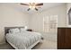 Cozy bedroom with a queen-size bed, natural light, and neutral decor at 7904 Fantail Dr, North Las Vegas, NV 89084