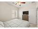 Cozy bedroom featuring a television, window with blinds, and closet for storage at 7904 Fantail Dr, North Las Vegas, NV 89084