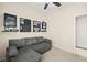 Cozy bedroom with a comfortable gray couch and ceiling fan at 7904 Fantail Dr, North Las Vegas, NV 89084