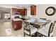 The dining area showcases dark wood cabinets, stainless steel appliances and views to the kitchen at 7904 Fantail Dr, North Las Vegas, NV 89084