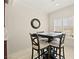 The dining area offers a modern table and chairs with ample natural light from a large window at 7904 Fantail Dr, North Las Vegas, NV 89084