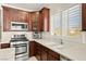 The chef's kitchen includes stainless steel appliances, dark wood cabinets and quartz countertops at 7904 Fantail Dr, North Las Vegas, NV 89084