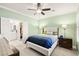 Inviting bedroom with a ceiling fan, ensuite bathroom, and a neutral color palette at 7904 Fantail Dr, North Las Vegas, NV 89084