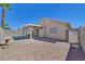 This backyard has a desert landscaped area and features a covered patio, perfect for outdoor enjoyment at 8472 W Gilmore Ave, Las Vegas, NV 89129