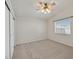 This bedroom features neutral carpeting, ceiling fan, and bright natural light at 8472 W Gilmore Ave, Las Vegas, NV 89129